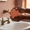 Pink Champagne Sparkle soap in use with women's hands
